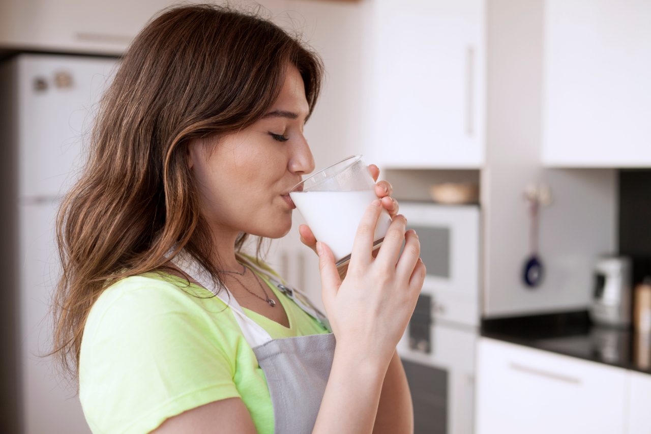 young woman drinking milk