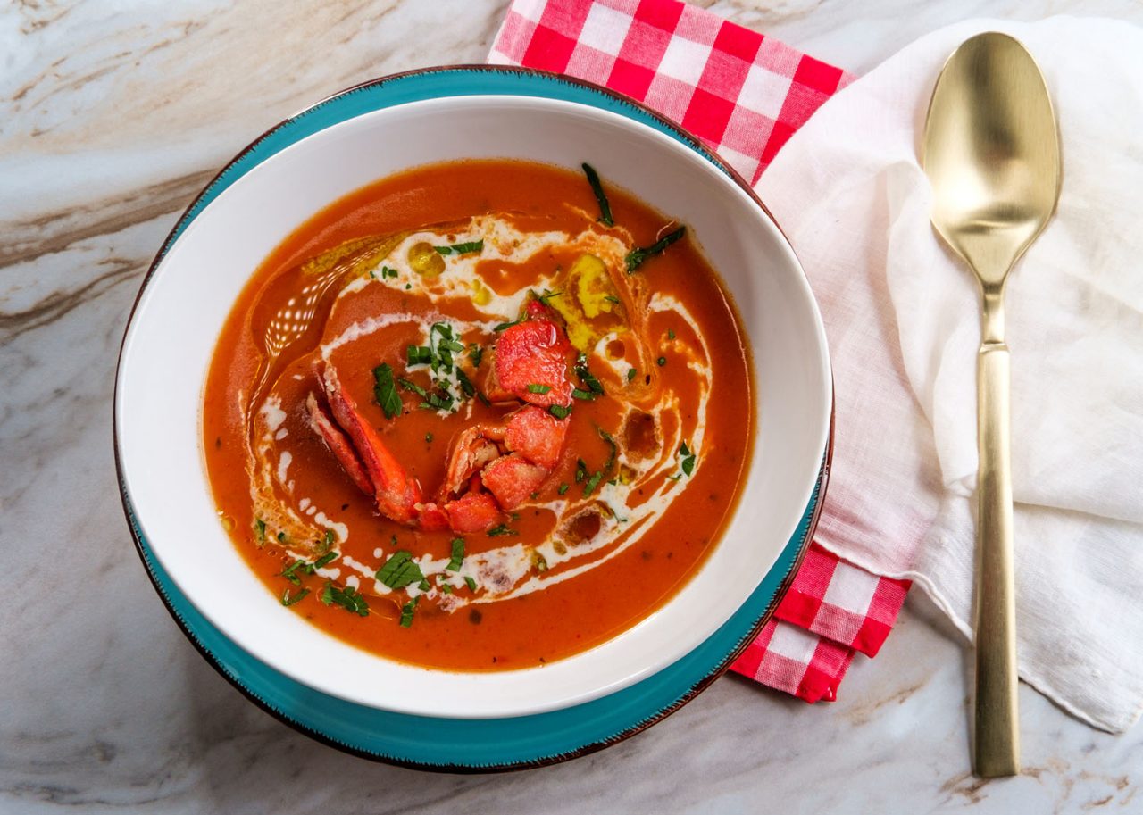 Fresh hot lobster bisque French soup with heavy cream and olive oil drizzle