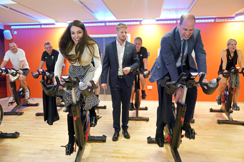 PORT TALBOT, WALES - FEBRUARY 28: Prince William, Prince of Wales and Catherine, Princess of Wales  take part in a spin class during a visit to Aberavon Leisure and Fitness Centre in Port Talbot, to meet local communities and hear about how sport and exercise can support mental health and wellbeing on February 28, 2023 in Port Talbot, United Kingdom. The Prince and Princess of Wales are visiting communities and mental health initiatives in South Wales ahead of St David's Day, which takes place on March 1. (Photo by Jacob King - WPA Pool/Getty Images)