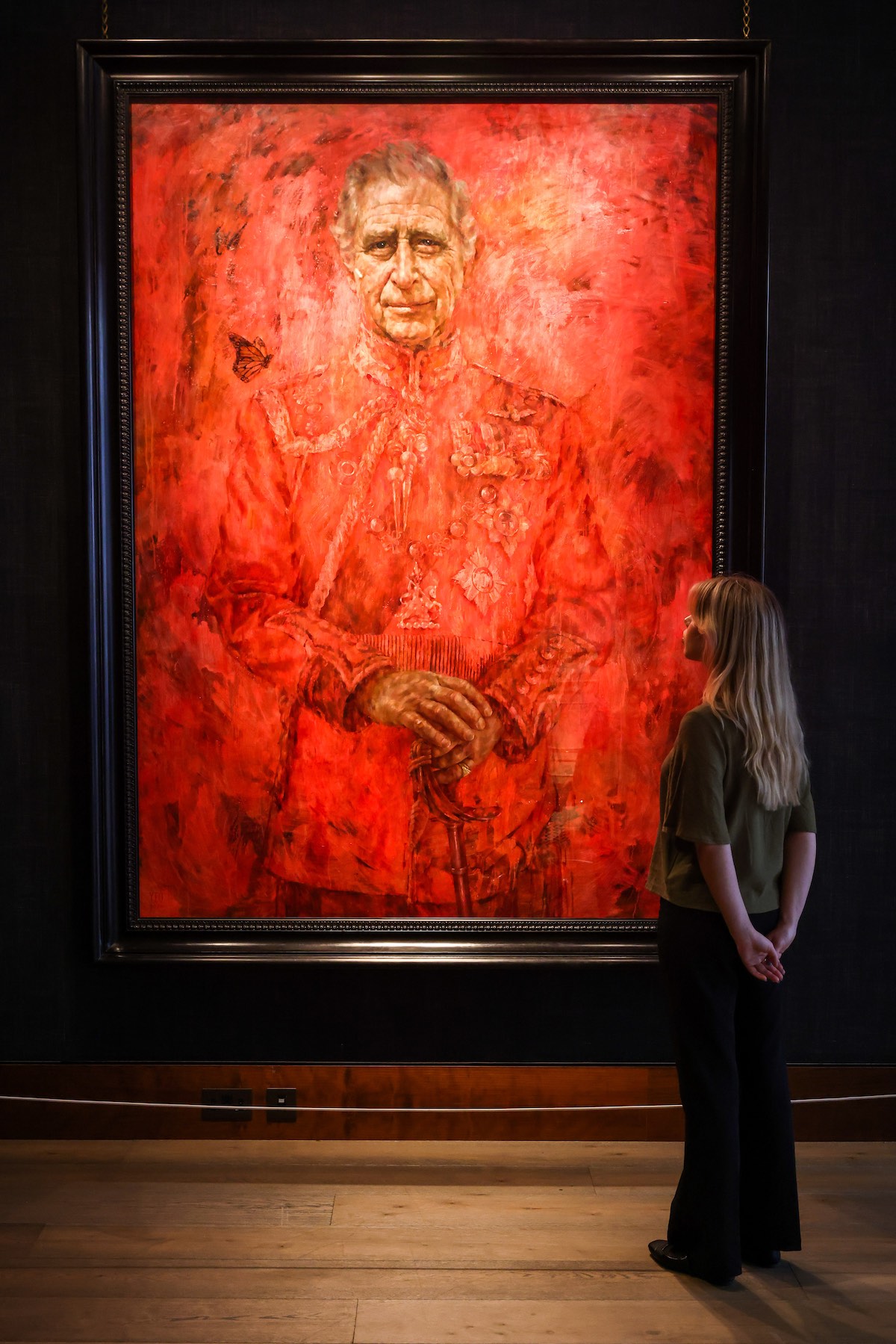 LONDON, UNITED KINGDOM - MAY 16: A woman views King Charles' first official portrait since the coronation painted by Jonathan Yeo on public display at Philip Mould Gallery in central London, Britain, May, 16, 2024. The painting about 8ft 6in by 6ft 6in in size shows King Charles in the uniform of the Welsh Guards. The painting will be on display until 14 June and will go on display in Drapers' Hall from the end of August. (Photo by Stringer/Anadolu via Getty Images)