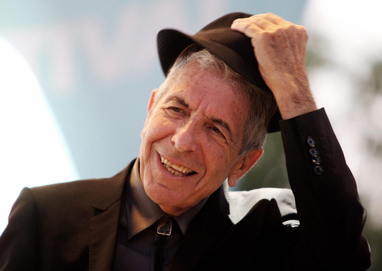 FILES) This file picture dated July 22, 2008 shows Canadian singer Leonard Cohen performing during the Nice Jazz Festival, in Nice, southern France. Canadian singer-songwriter Leonard Cohen, who turns 75 on September 21, 2009, was released from a hospital in Spain on September 19, 2009, hours after collapsing on stage during a concert, hospital sources said. Organisers of his concert in the eastern city of Valencia said he had fainted on stage after being stricken with food poisoning.AFP PHOTO VALERY HACHE (Photo credit should read VALERY HACHE/AFP via Getty Images)