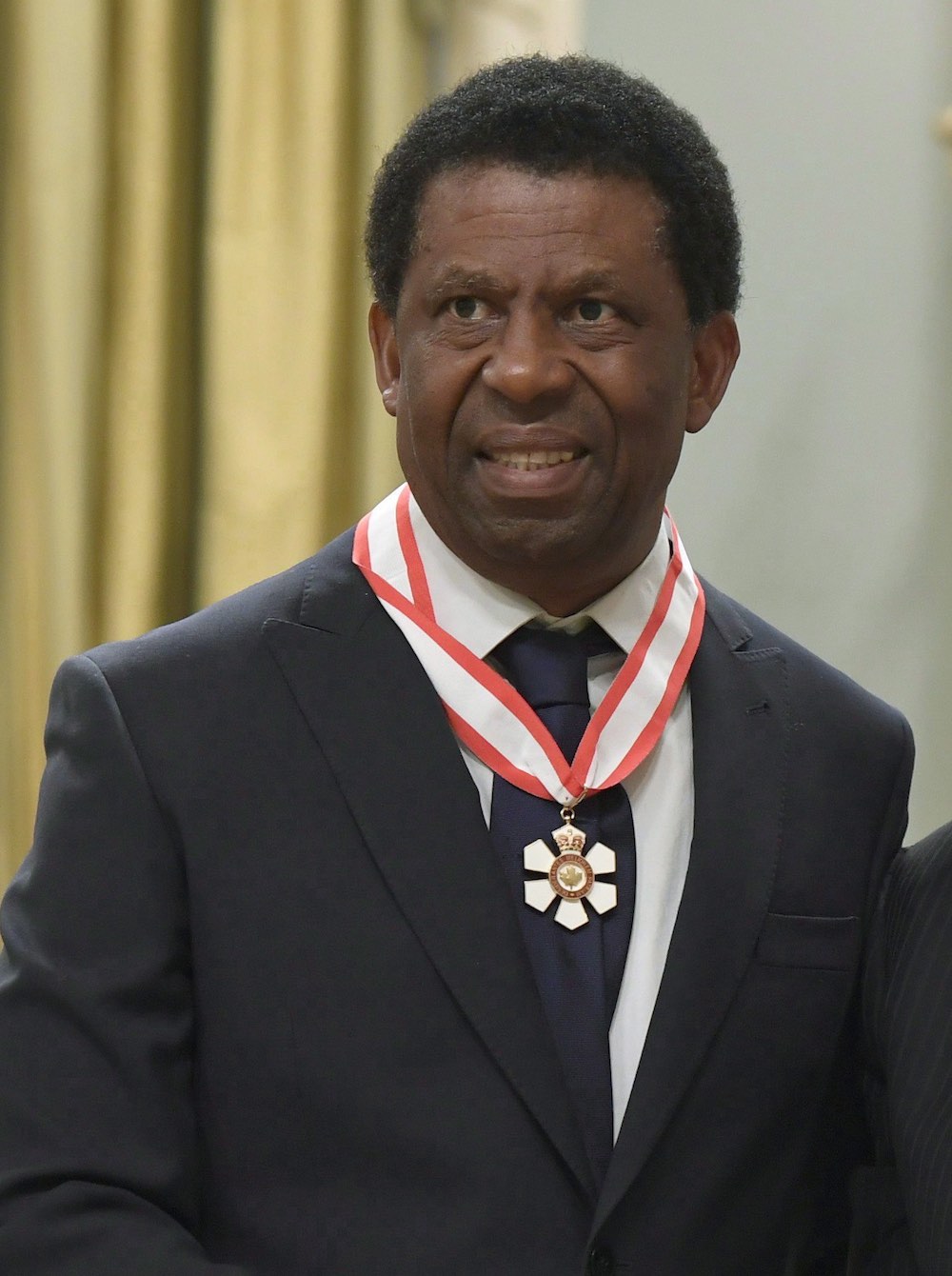 French-Canadian author Dany Laferriere, of Montreal, is invested as an officer of the Order of Canada by Governor General David Johnston during a ceremony at Rideau Hall in Ottawa on Friday, August 25, 2017. THE CANADIAN PRESS/Justin Tang