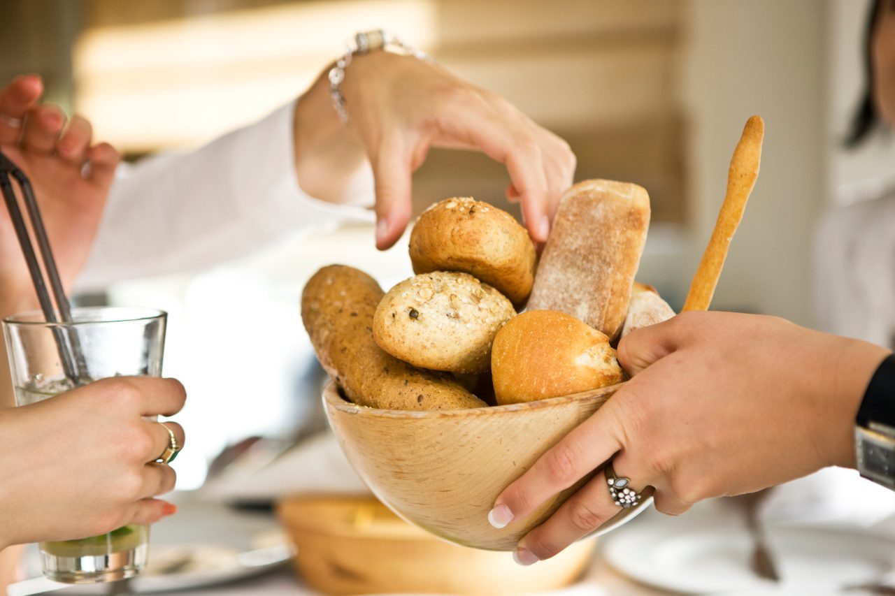 "Woman giving bread, selective focus, canon 1Ds mark III"