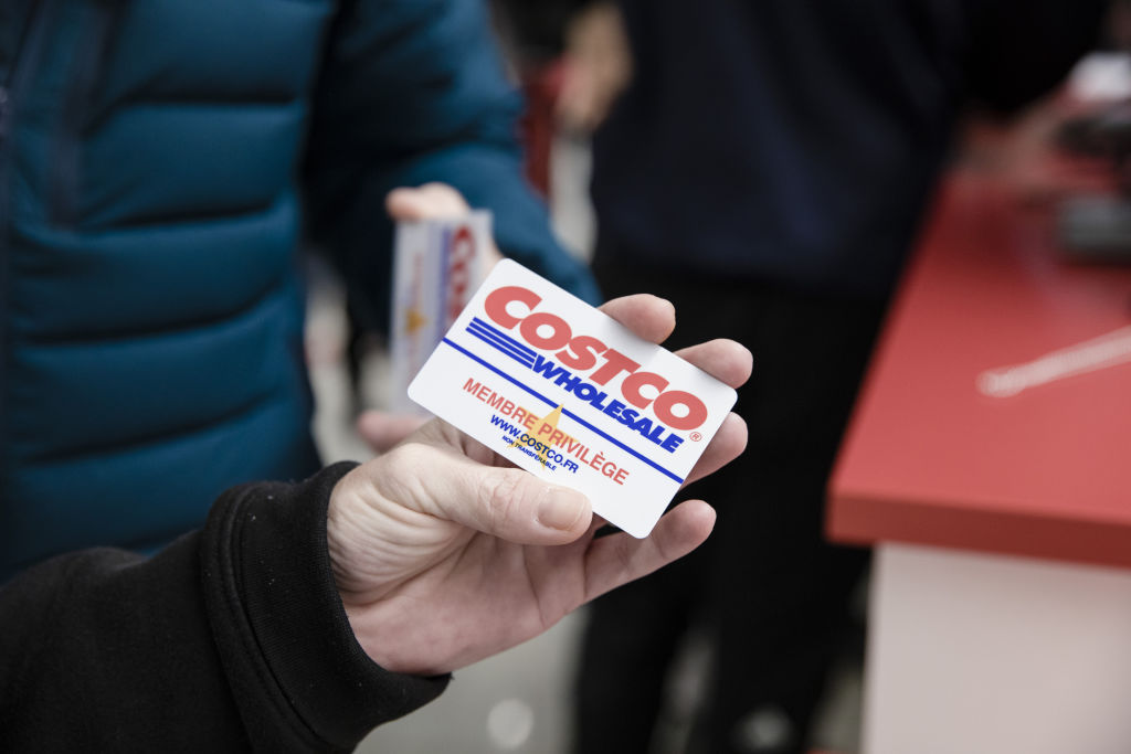 A customer shows their membership card in this arranged photograph inside a Costco Wholesale Corp.Â store in Villebon-sur-Yvette, France, on Friday, Nov. 3, 2017. About an hour south of Paris, a uniquely American import has opened for business. Photographer: Marlene Awaad/Bloomberg via Getty Images