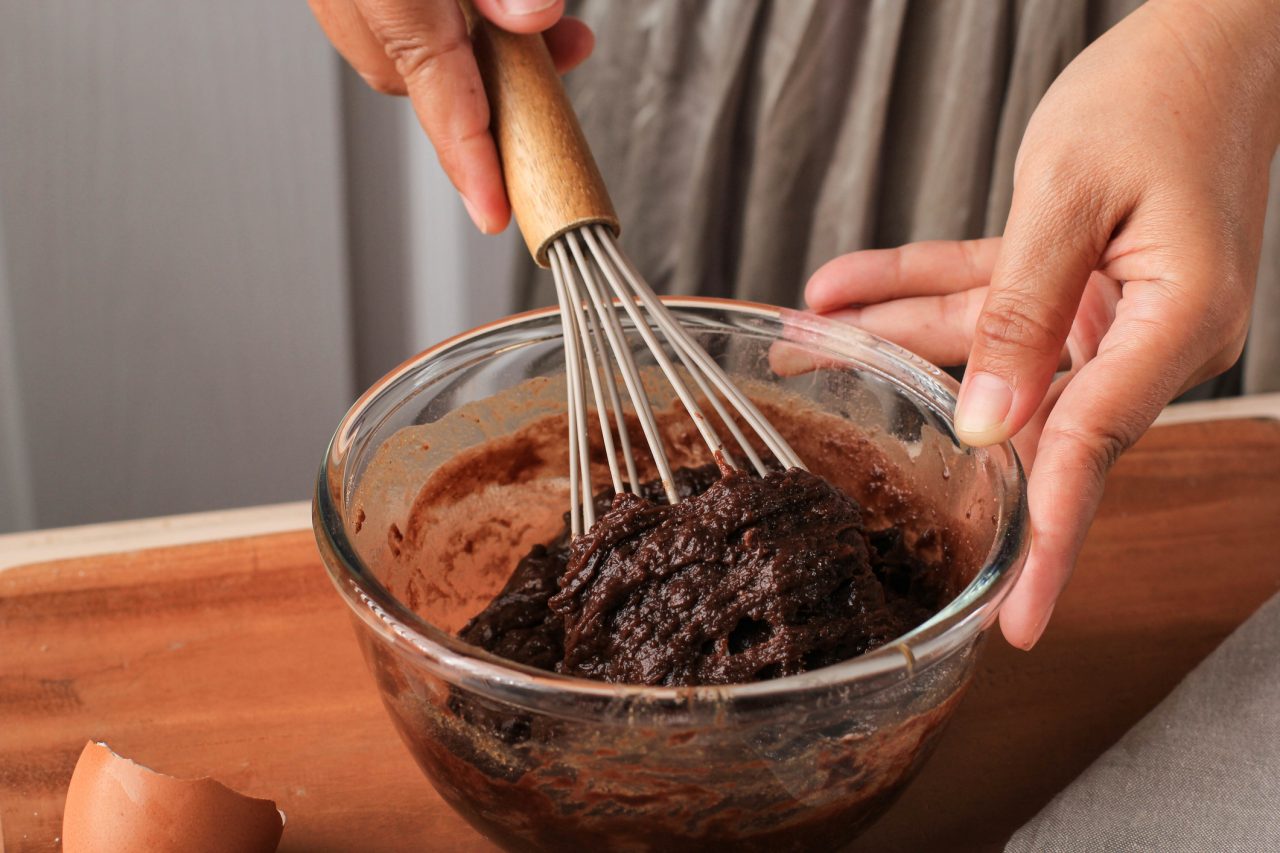 Woman Hand Mixed Chocolate Batter on Clear Bowl with Baloon Whisk Step by Step Baking Preparation in the Kitchen, Making Chocolate Cake or Brownies
