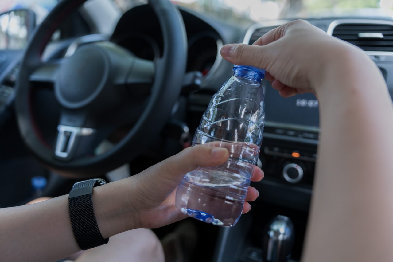 Plastic water bottles and glasses in the car