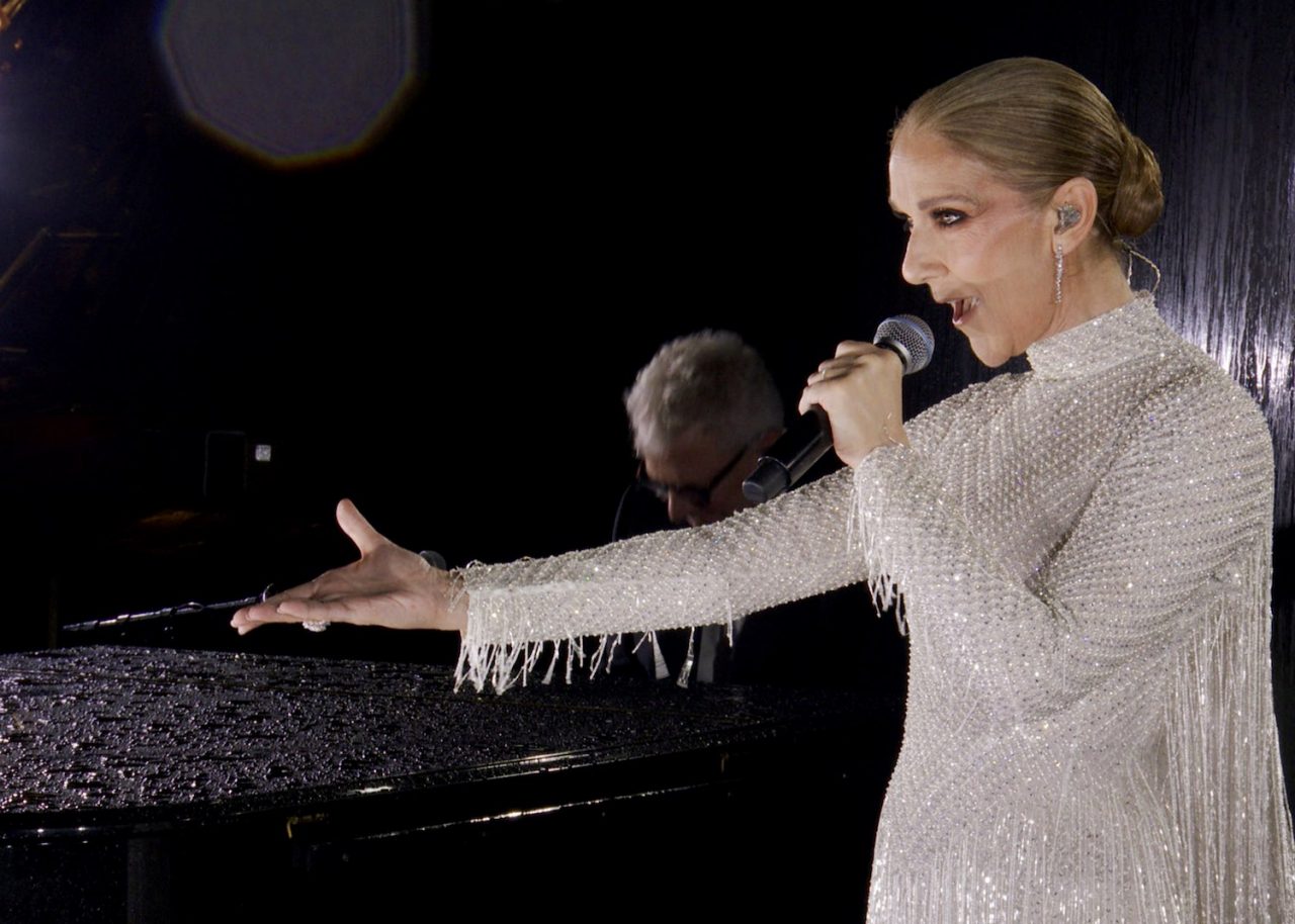 PARIS, FRANCE - JULY 26: (EDITOR'S NOTE: This Handout screengrab was provided by a third-party organization and may not adhere to Getty Images' editorial policy.) This handout released by the Olympic Broadcasting Services, shows a view of singer Celine Dion performing on the Eiffel Tower during the opening ceremony of the Paris 2024 Olympic Games Paris 2024 on July 26, 2024 in Paris, France. (Screengrab by IOC via Getty Images)